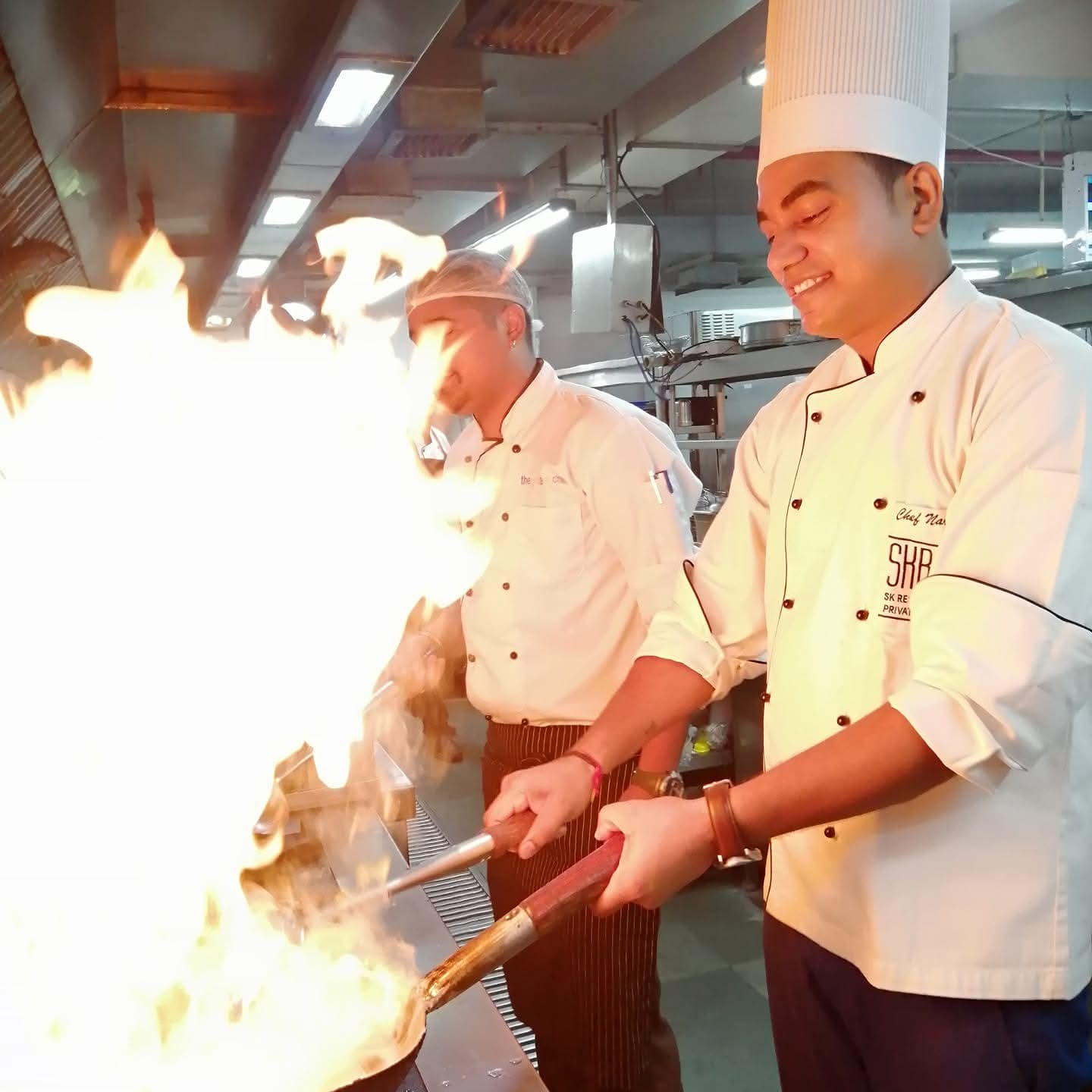 Chefs flambéing at the tandoor